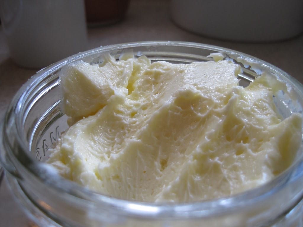Pale homemade butter in a jar