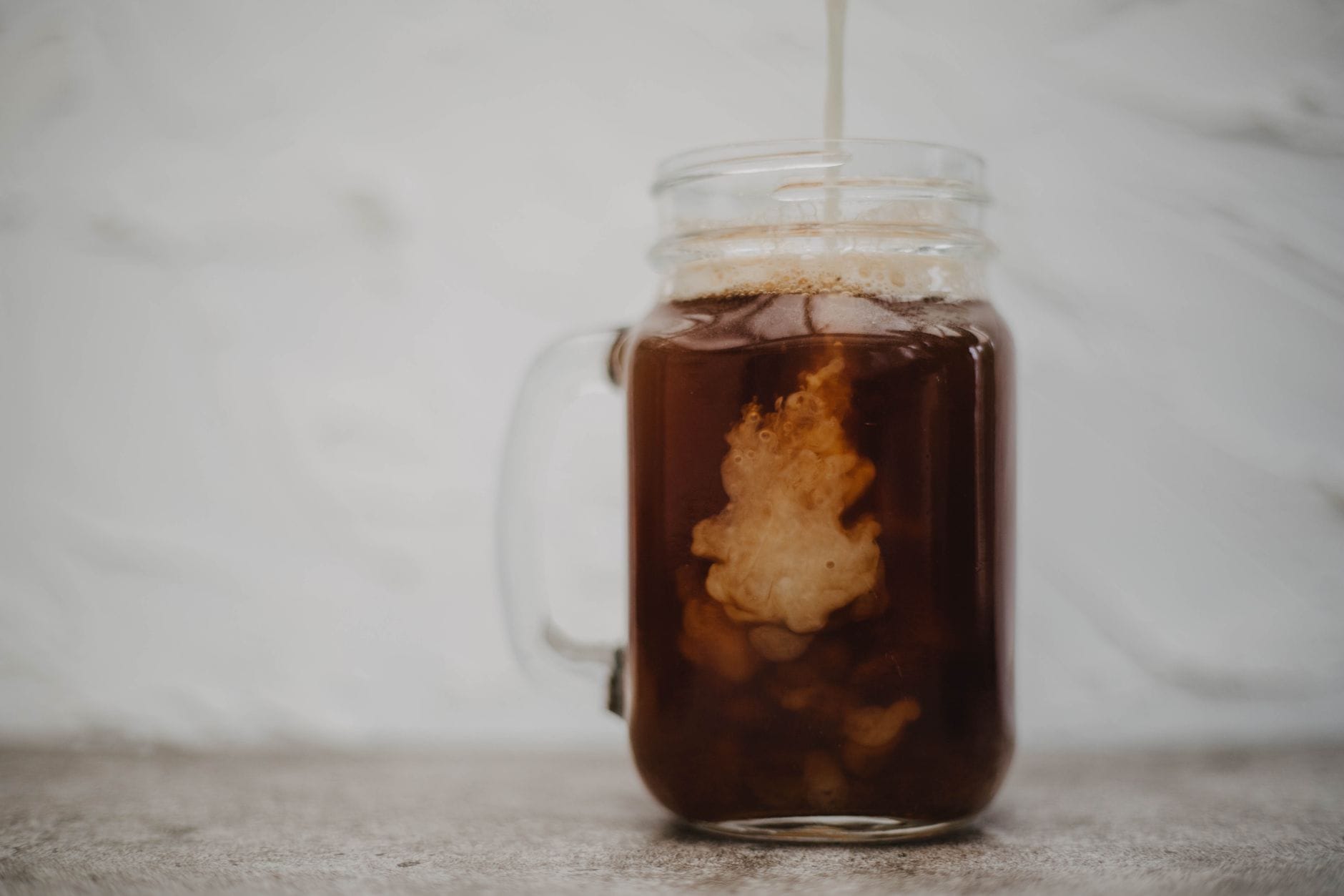 A jar of kombucha with a SCOBY