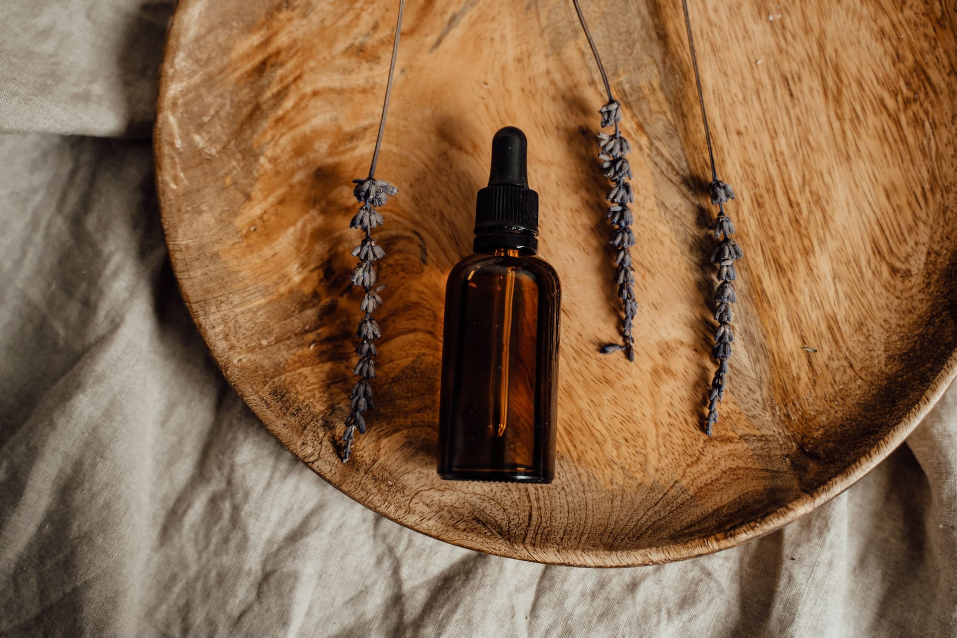 An amber dropper bottle with dried lavender