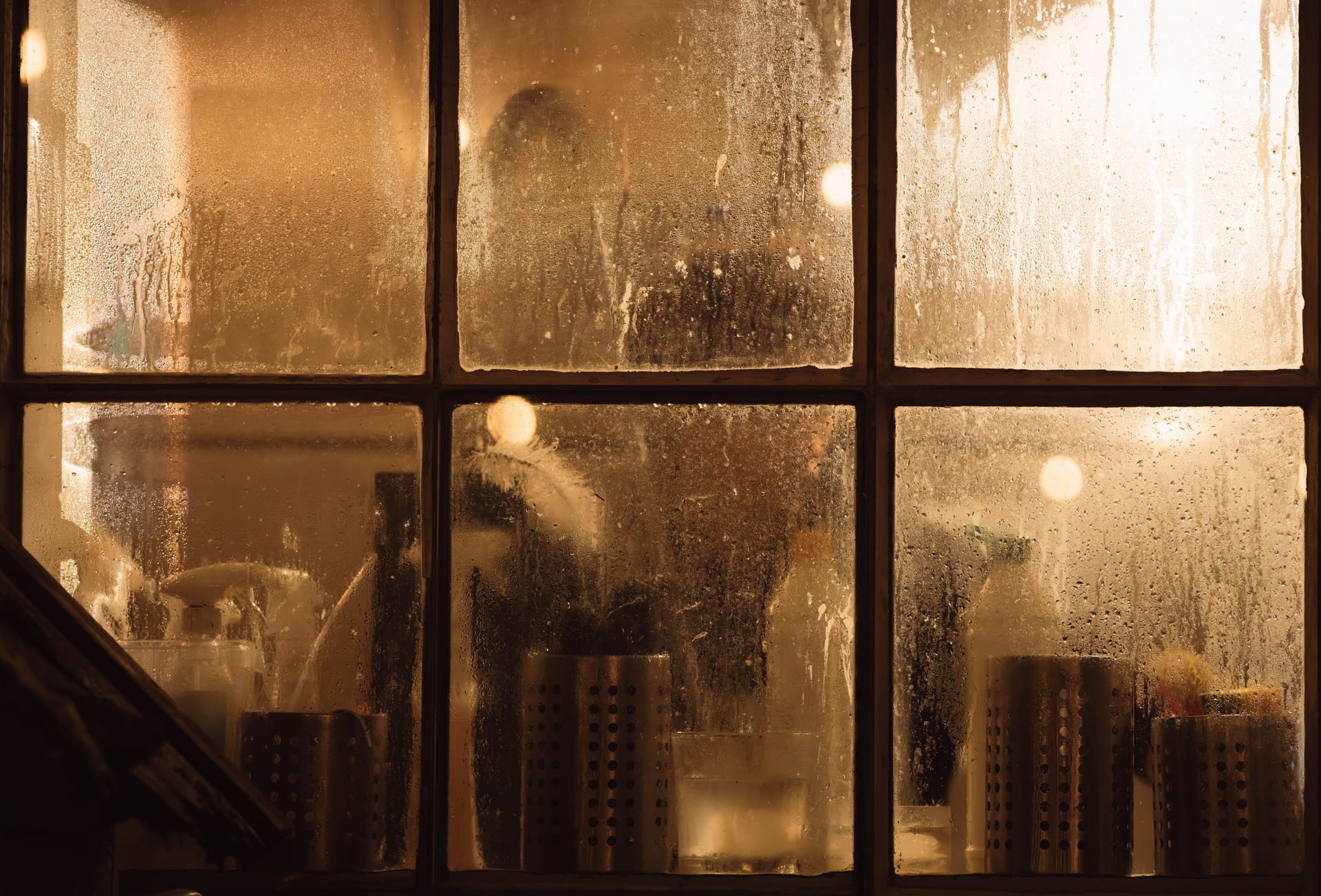 Condensation fogging a window looking into a warm room