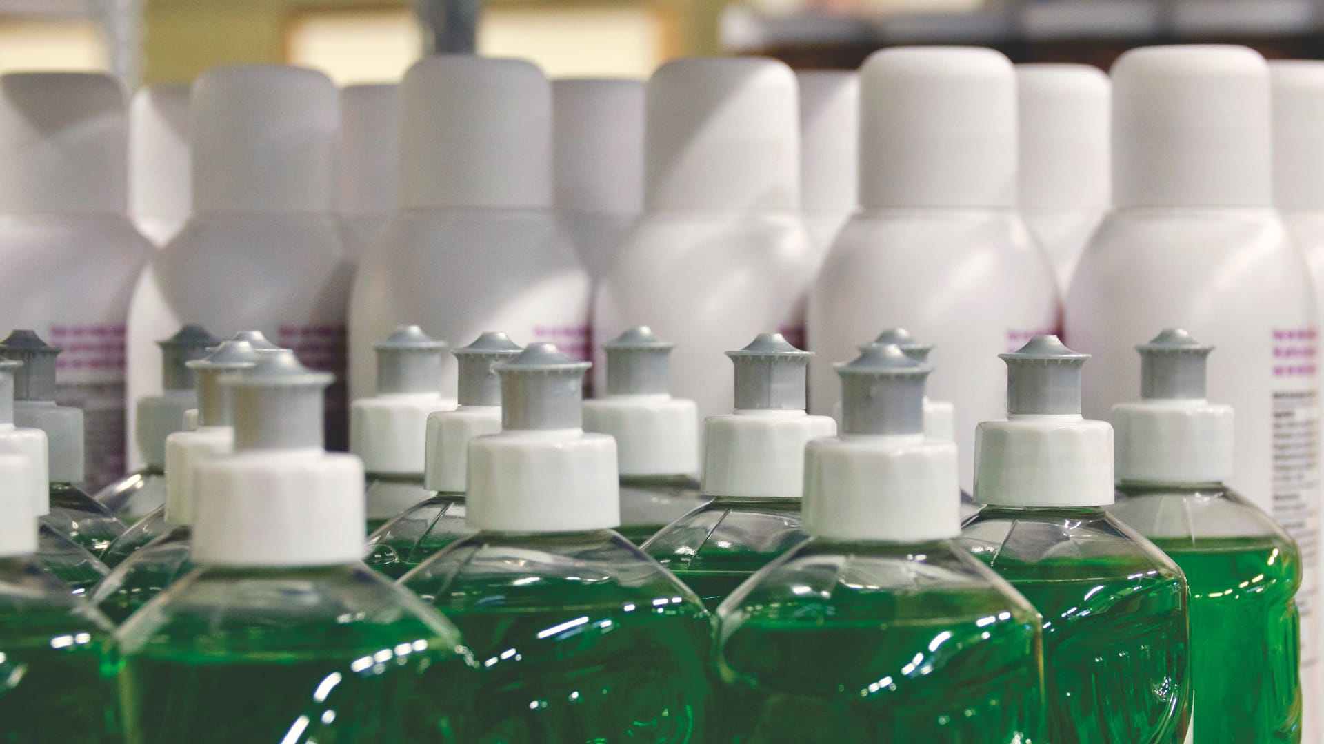 Close-up of coloured cleaning liquids in bottles