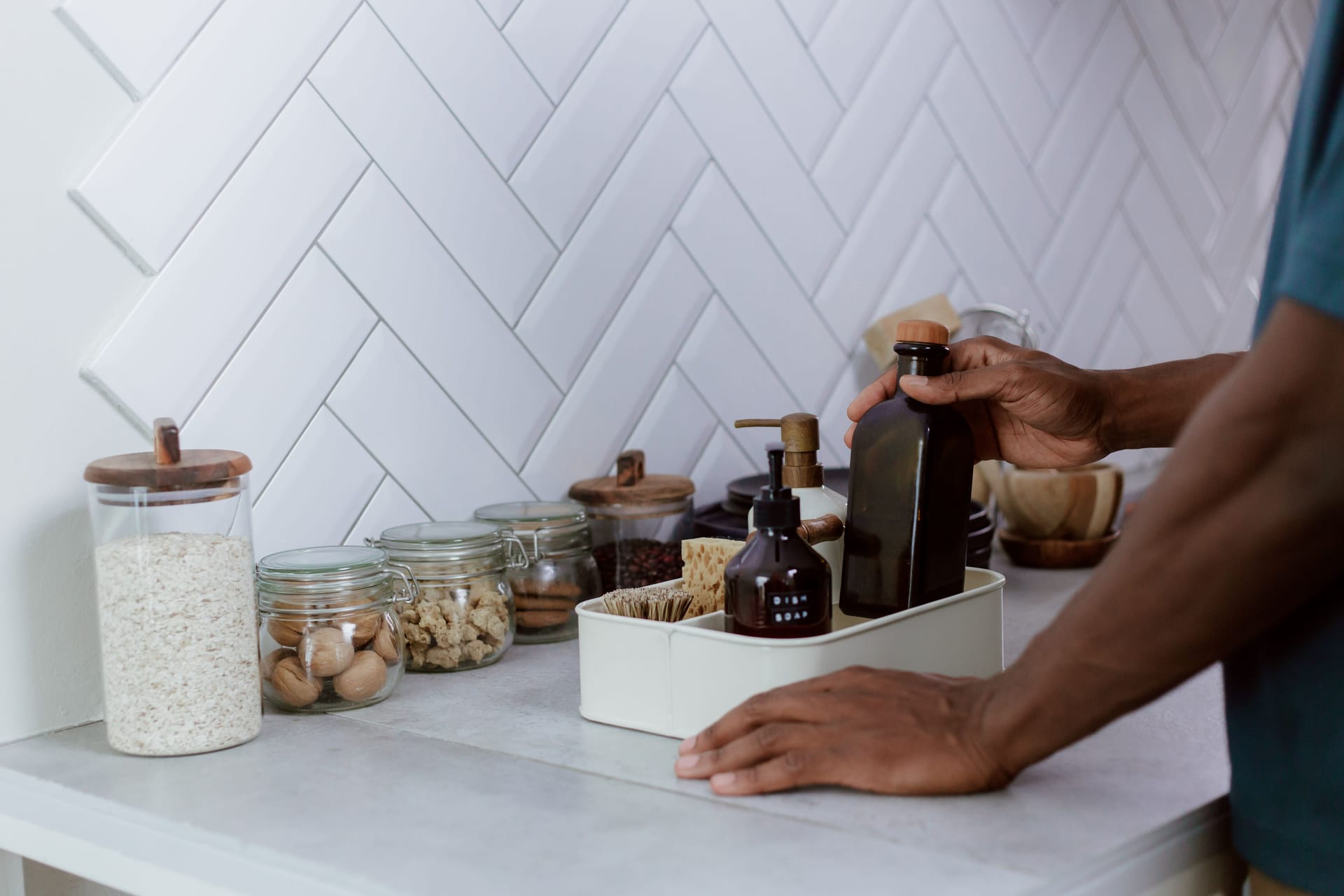 Reusable glass jars and bottles on a kitchen counter