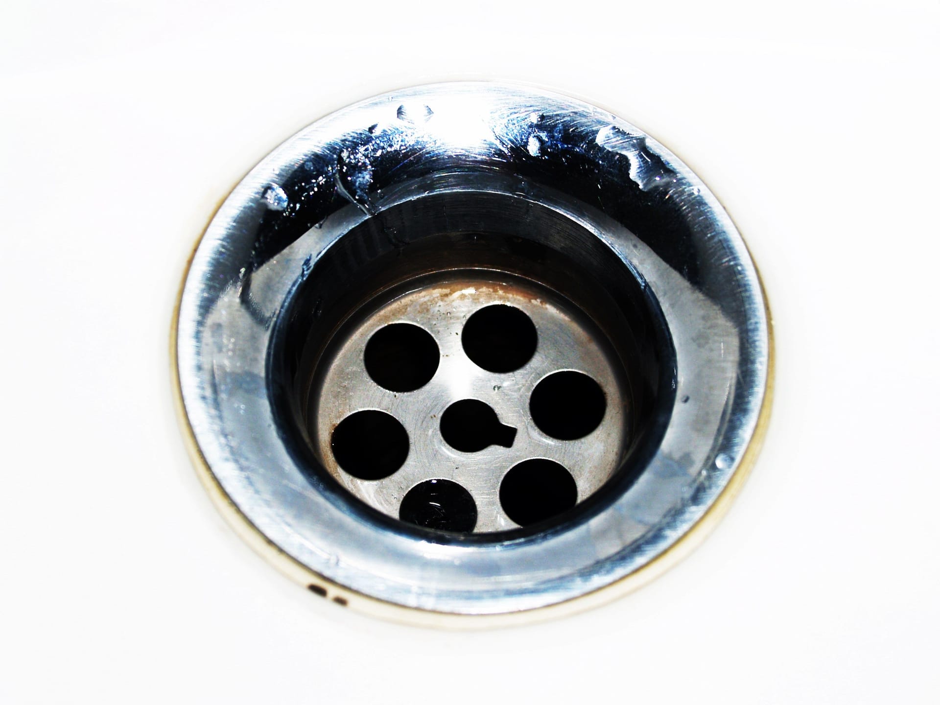 A close-up of a chrome sink drain