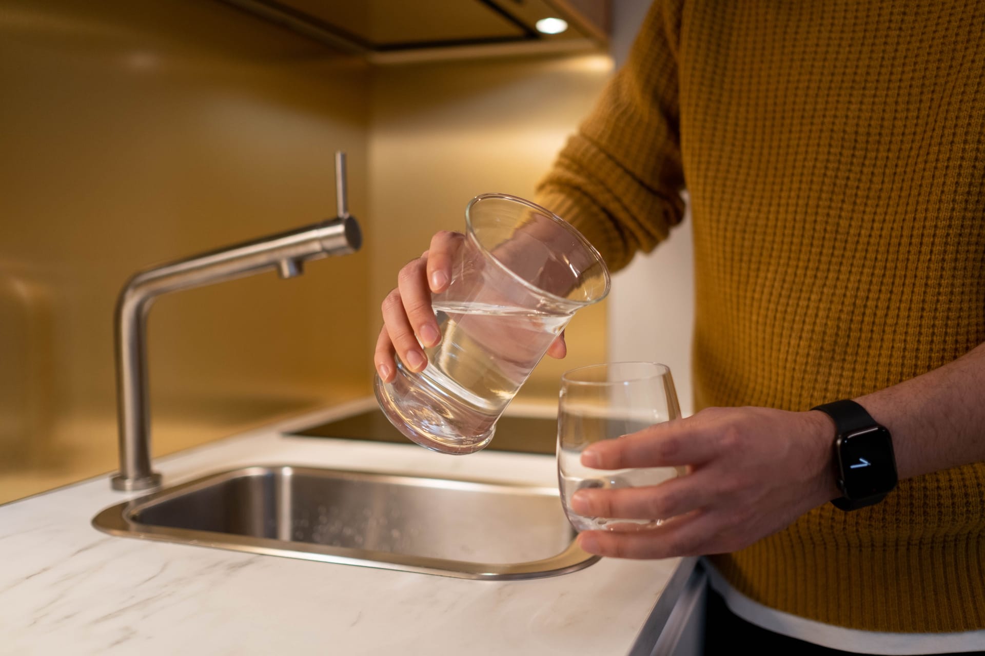 Pouring filtered water from a jug into a glass
