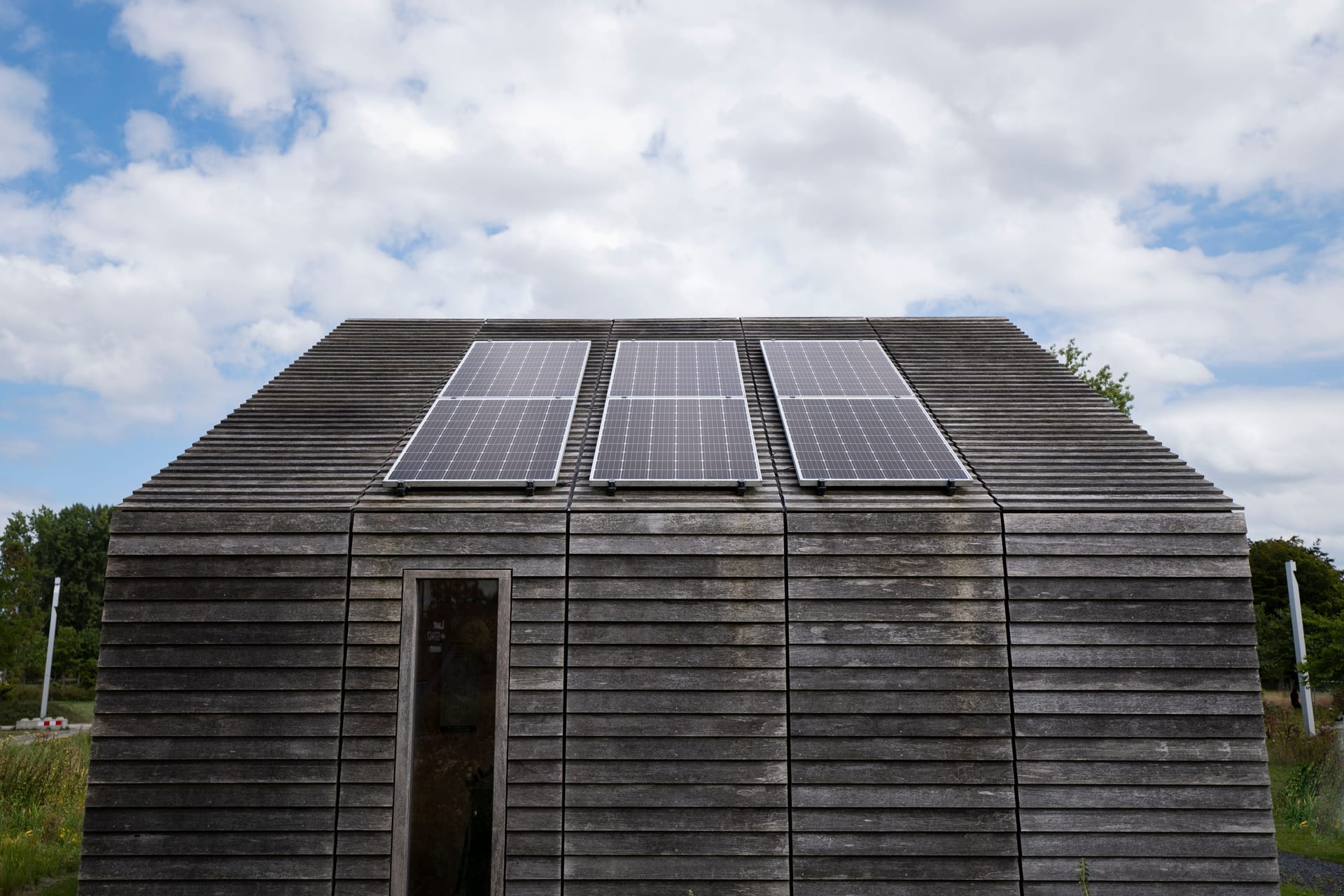 A timber barn with roof-mounted solar panels