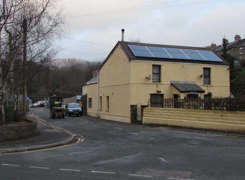 Roof-mounted solar panels on a house under a winter sky
