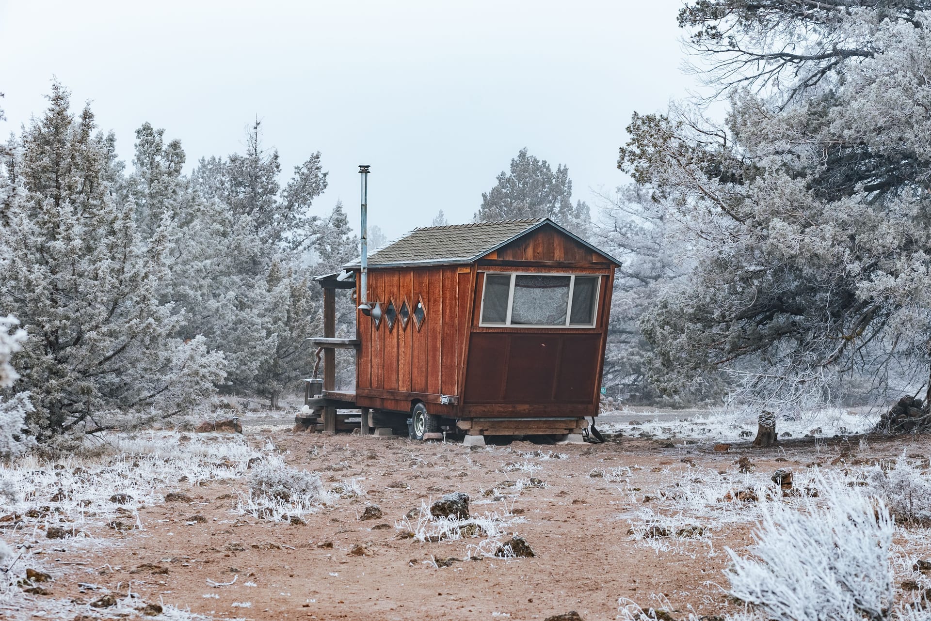 A small timber cabin among frosty trees