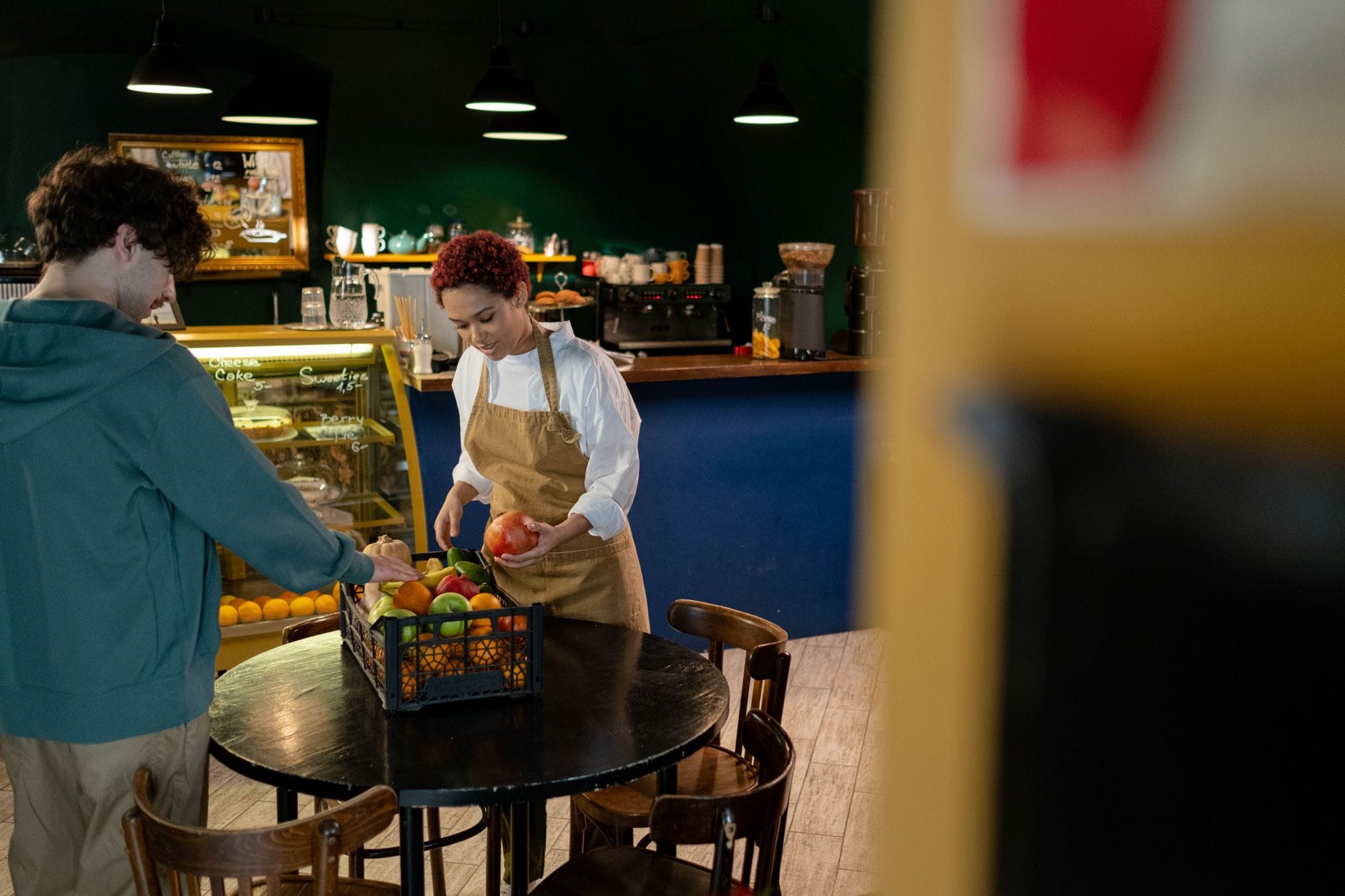 A market vendor serving a customer