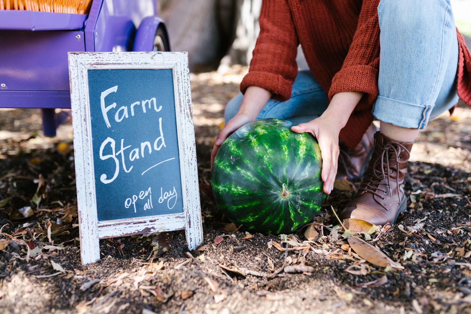 A hand-lettered 'Farm Stand' chalkboard sign