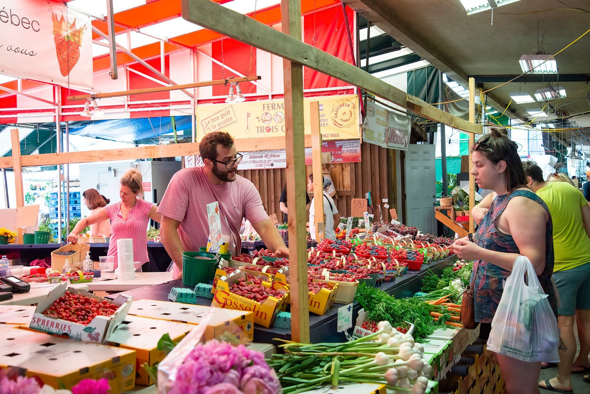 A busy farmers market produce stall