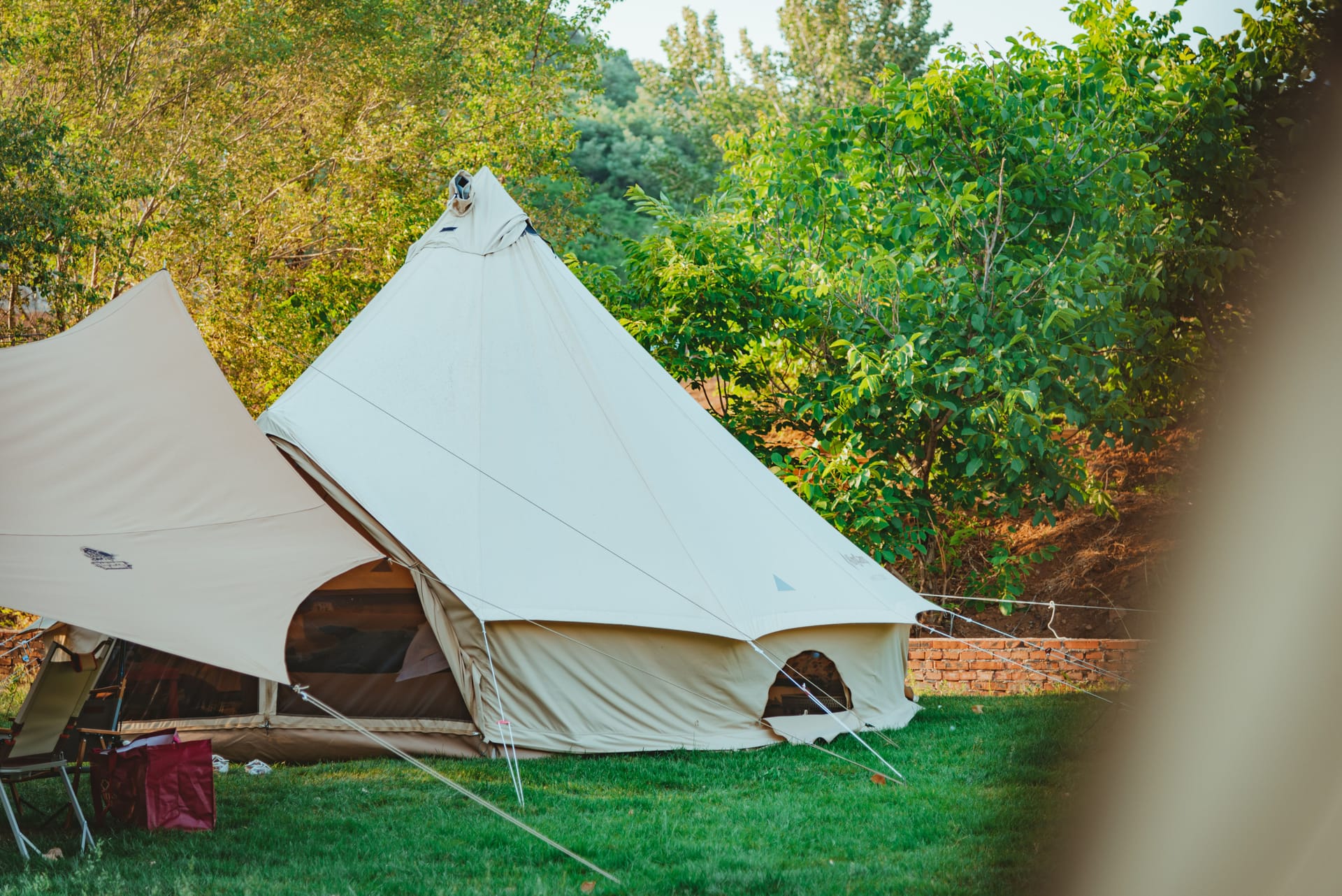 A bell tent pitched in a green field