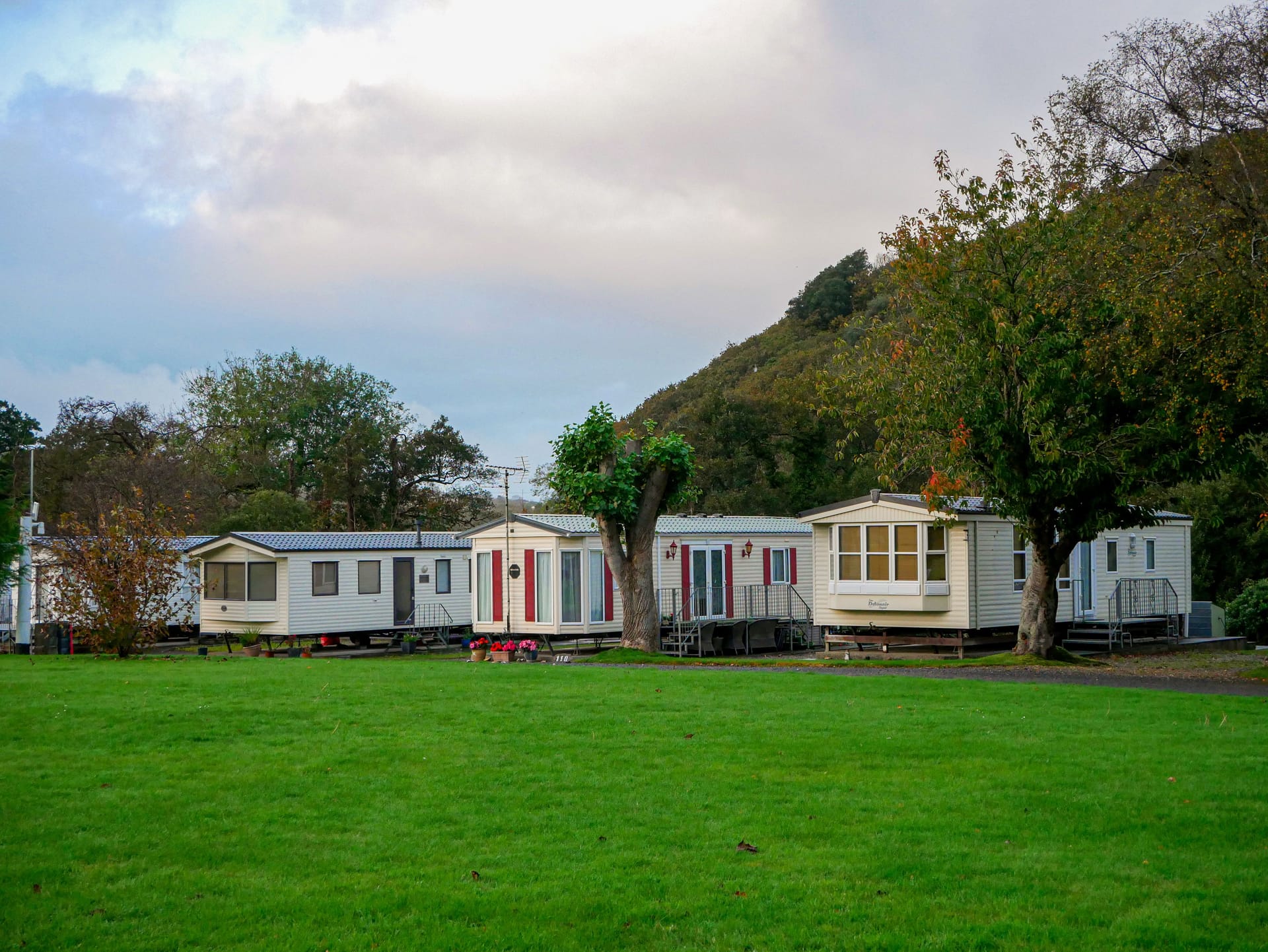 Static caravans among green countryside hills