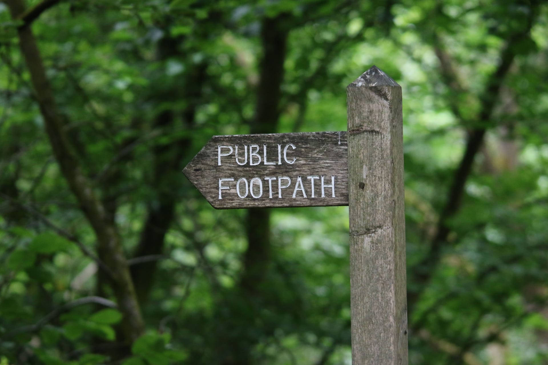 A wooden signpost for a public footpath